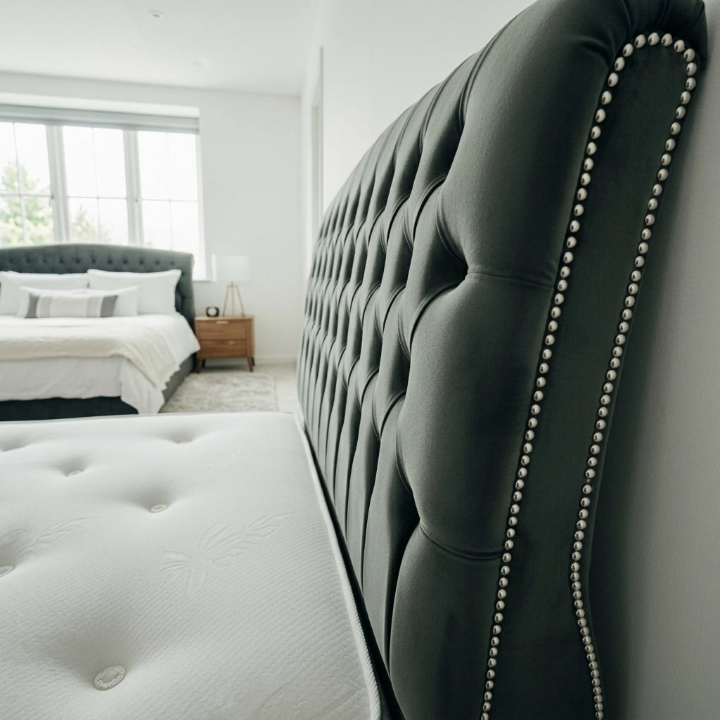 Close up of plush velvet curved sleigh headboard with stud detailing