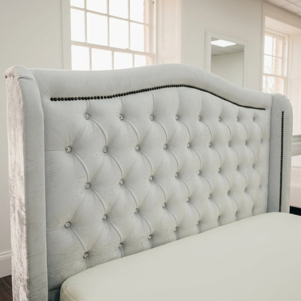 Close up of white curved button and beading headboard